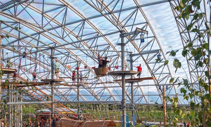 An image of the multi-level, bespoke aerial adventure course that you'll find underneath the Serendome's transparent roof.